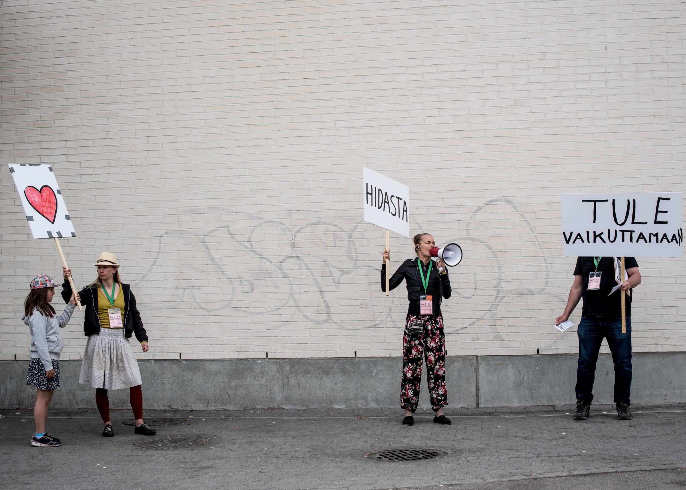 Actors on the street demonstrating with signs.