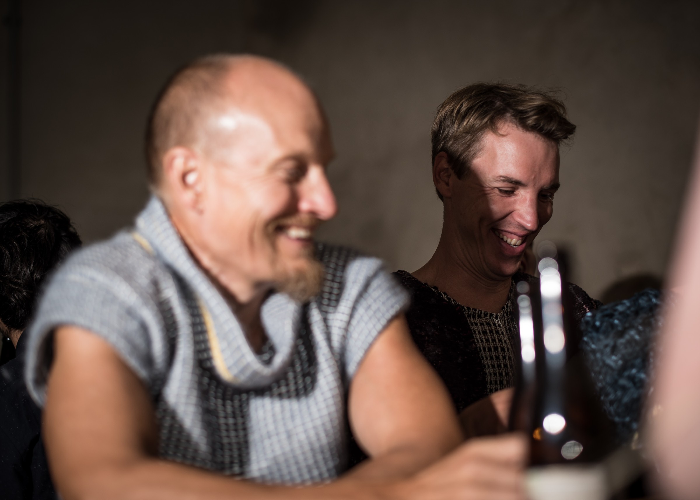 Two men having drinks after fashion show
